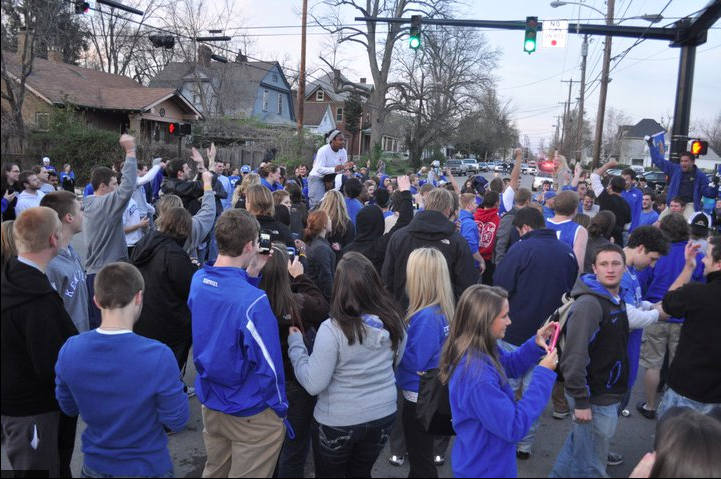 UK fans crowd at the corner of Woodland and Euclid